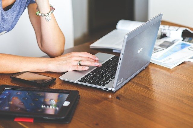 Woman typing on a laptop keyboard