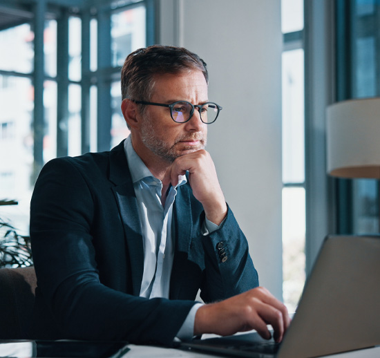 Thoughtful man working on laptop