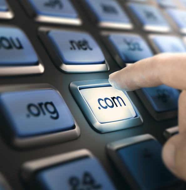 Finger pressing .com key on keyboard.