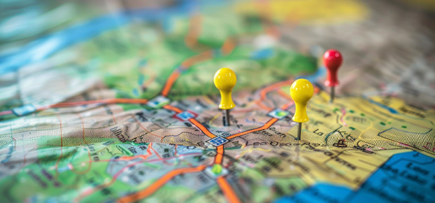 Map with yellow and red pushpins.