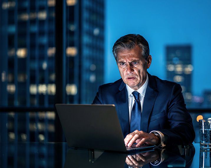 Concerned man working on laptop.