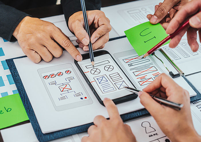 Smartphone mockup with design sketches.