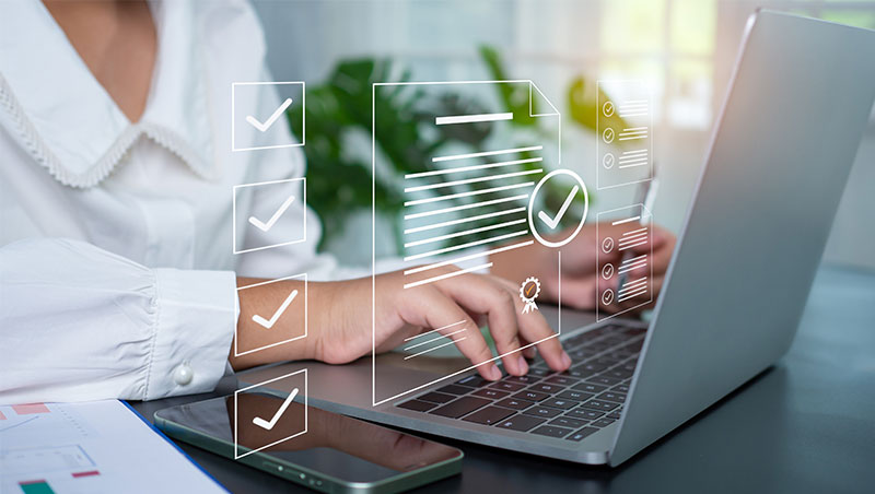 Laptop with checklists and documents.