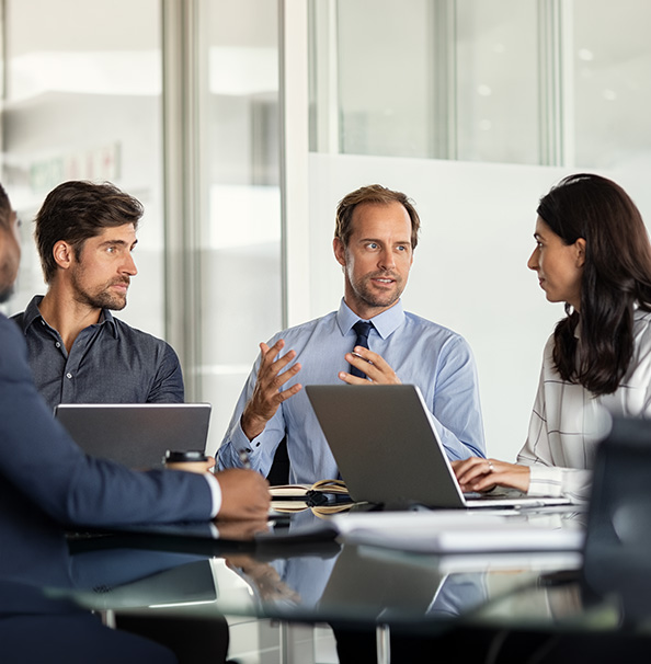 Business meeting around laptops