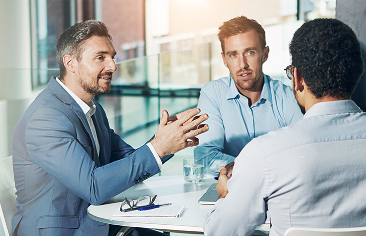 Three men in meeting